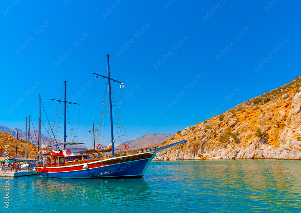 traditional wooden big sailing boat docked at the port of Vathi village in Kalymnos island in Greece traditional wooden big sailing boat docked at the port of Vathi village in Kalymnos island in Greece