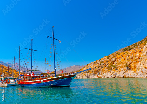 traditional wooden big sailing boat  docked at the port of Vathi village in Kalymnos island in Greece photo