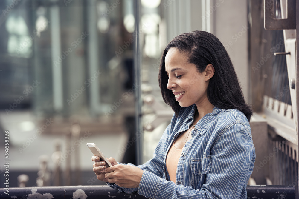 A young woman checking her cell phone A young woman checking her cell phone