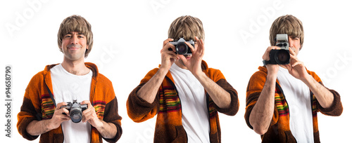 Blonde man photographing over white background