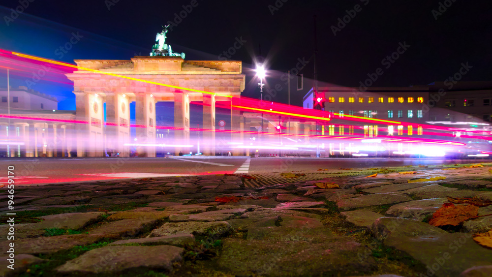 Fototapeta premium Brandenburg Gate and car light trails at night in Berlin