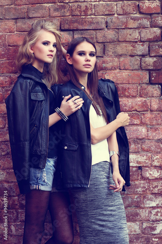 Two young fashion women posing outdoor. © MaxFrost
