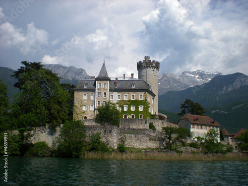 Castle with lake, surrounding by mountains. #94659951
