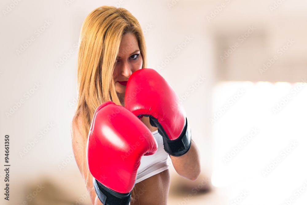 Blonde girl with boxing gloves