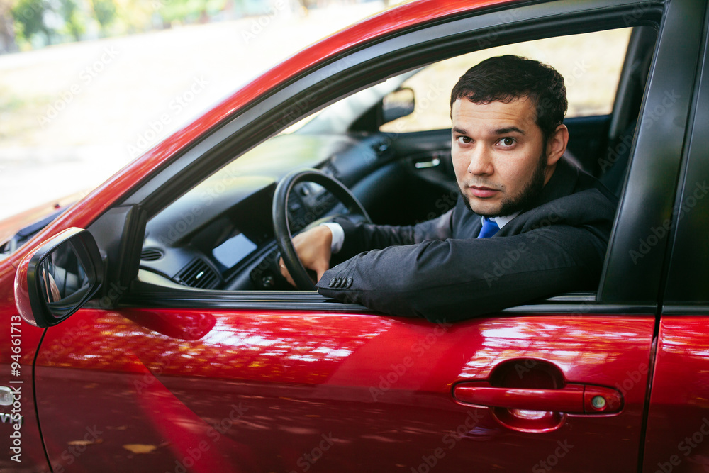 Handsome young man driving a car. Handsome young man driving a car.