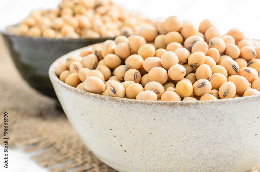 soybeans in ceramic bowl on sackcloth background.. soybeans in ceramic bowl on sackcloth background..