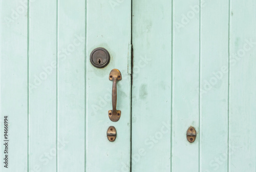 Closeup old  and pale green wooden door background © kenkuza
