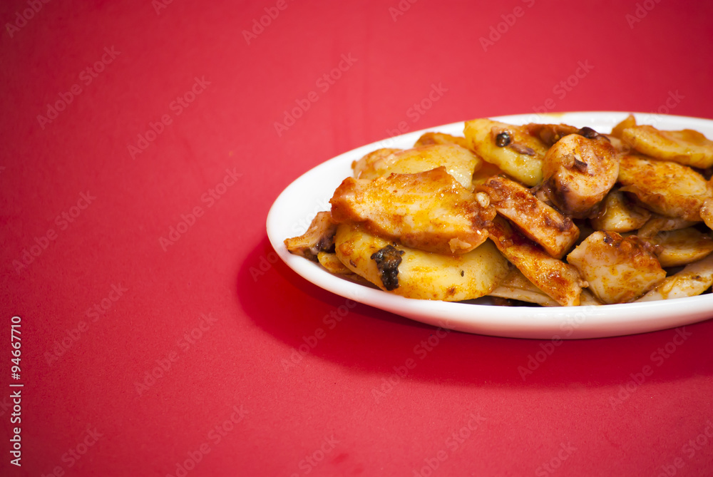 Octopus with paprika on a white plate, also known as Galician oc Octopus with paprika on a white plate, also known as Galician oc