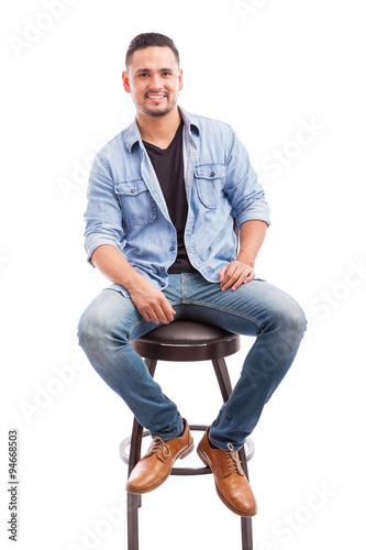 Good looking man sitting in a chair