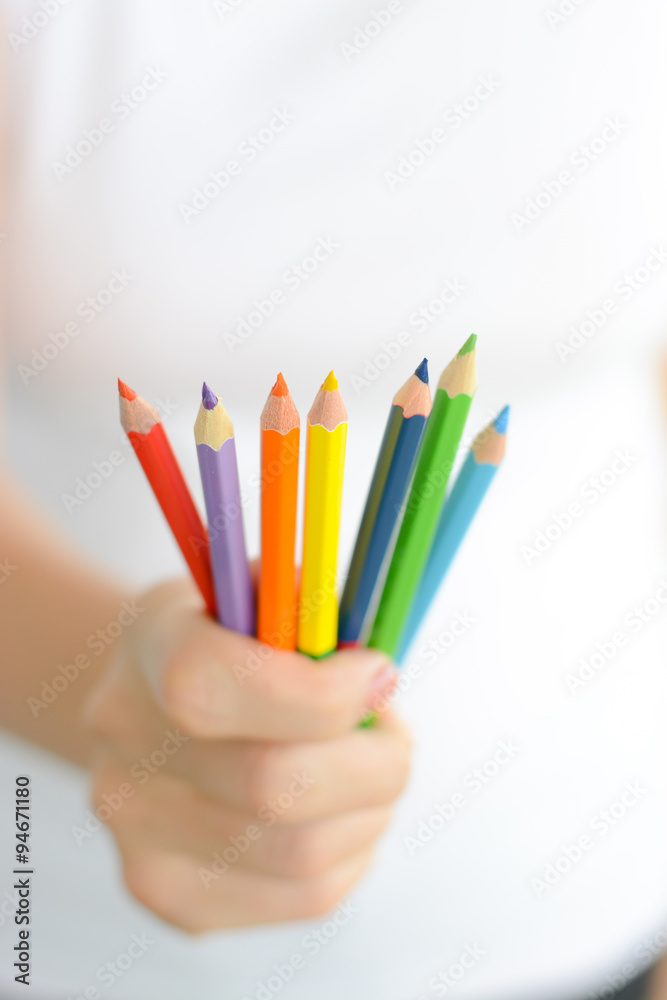 Fototapeta premium Woman holding colorful pencils in hand