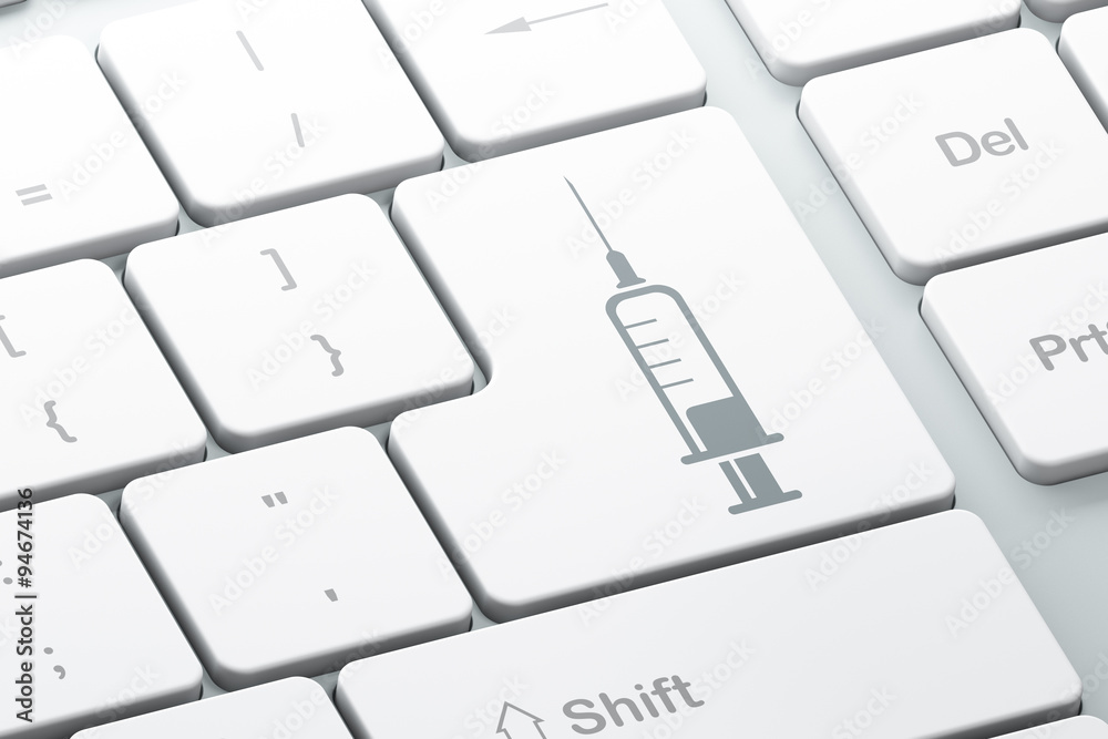 Healthcare concept: Syringe on computer keyboard background Healthcare concept: Syringe on computer keyboard background