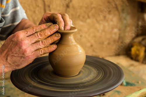 Old potter creating a new ceramic pot