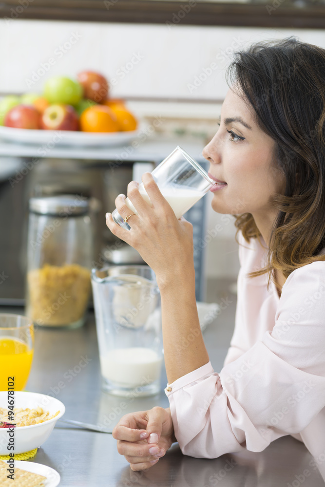 Attractive young woman drinking milk