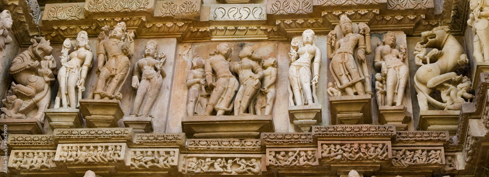 Stone carved erotic bas relief in Hindu temple in Khajuraho, India. Unesco World Heritage Site