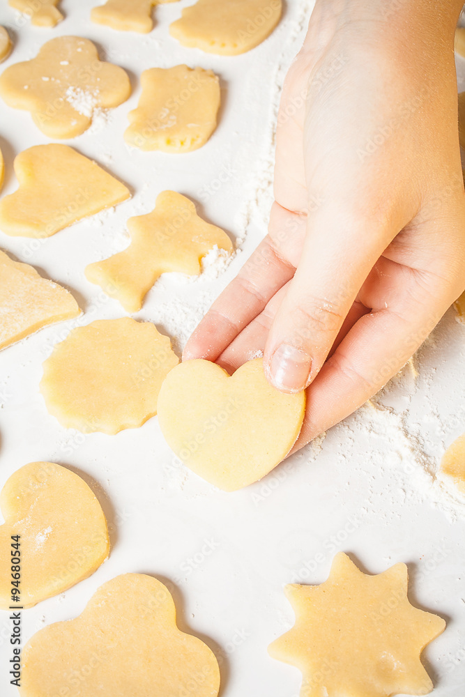 Girl shows heart shape out of dough Girl shows heart shape out of dough