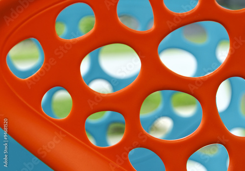 Orange und blaue gelochte Kunststoffrückenlehnen