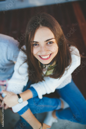 Top view of smiling teenage girl wearing casual wear. Portrait of young woman looking up