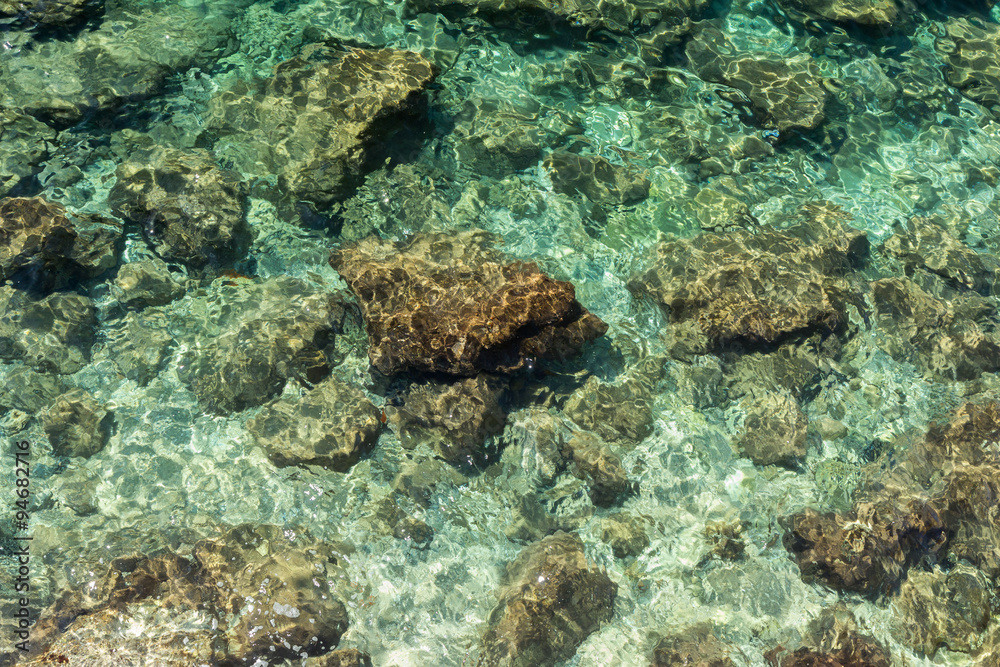 Fototapeta premium Rocky coastline and shallow water viewed from above in Dubrovnik, Croatia.