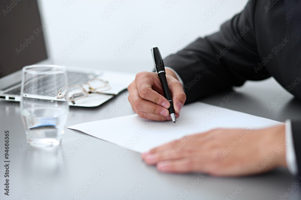 Close-up of male hands with pen over document, business concept Close-up of male hands with pen over document, business concept