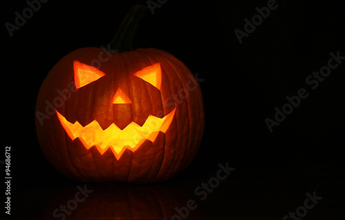 Halloween glowing pumpkin on black background