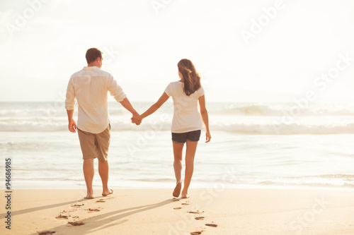 Couple Walking along the Ocean at Sunset