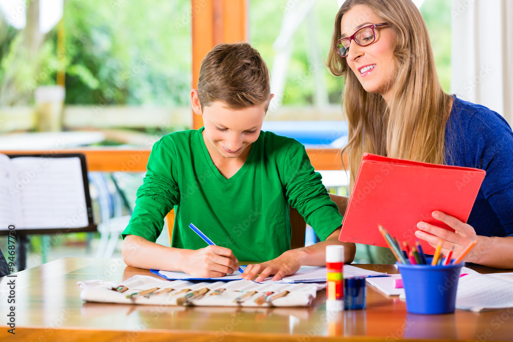 Fototapeta premium Mother helping son with homework assignment