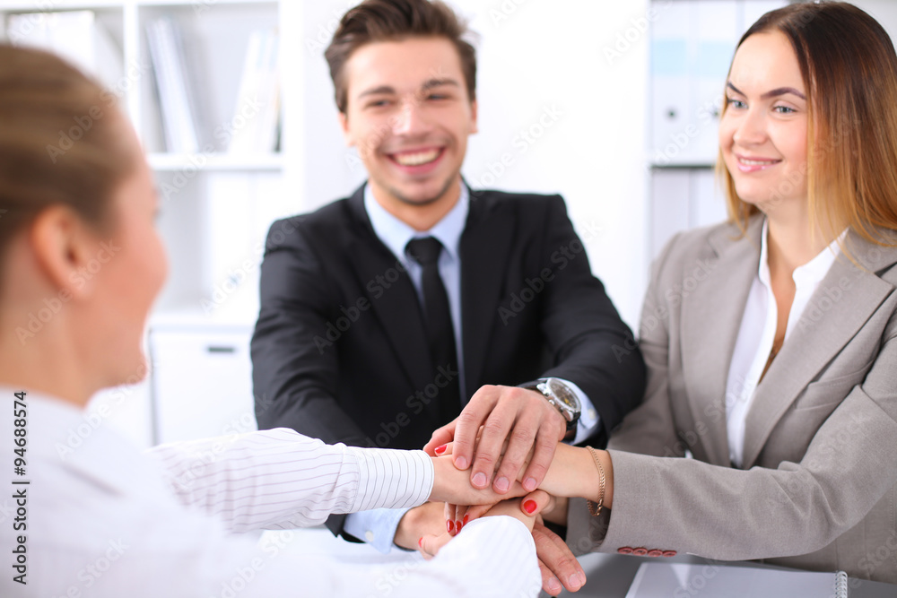 Business people group joining hands and representing concept of friendship and teamwork Business people group joining hands and representing concept of friendship and teamwork