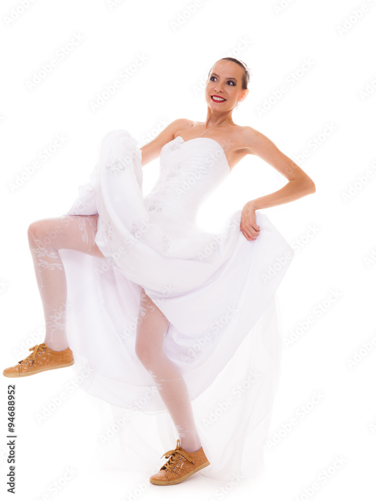 Fototapeta premium Wedding. Running bride funny woman in sport shoes