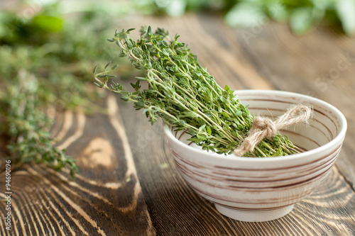 bundle of thyme on a brown wooden background