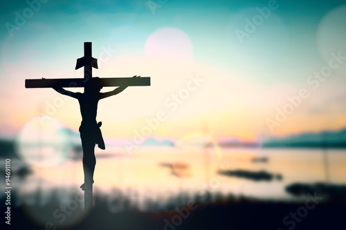 Silhouette of Jesus with Cross over rainbow sunset concept for religion, worship, Christmas, Good Friday,  Easter, Jesus he is risen, Thanksgiving prayer and praise, promise