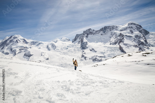 A man in camouflage winter coat waving his hand in front of the