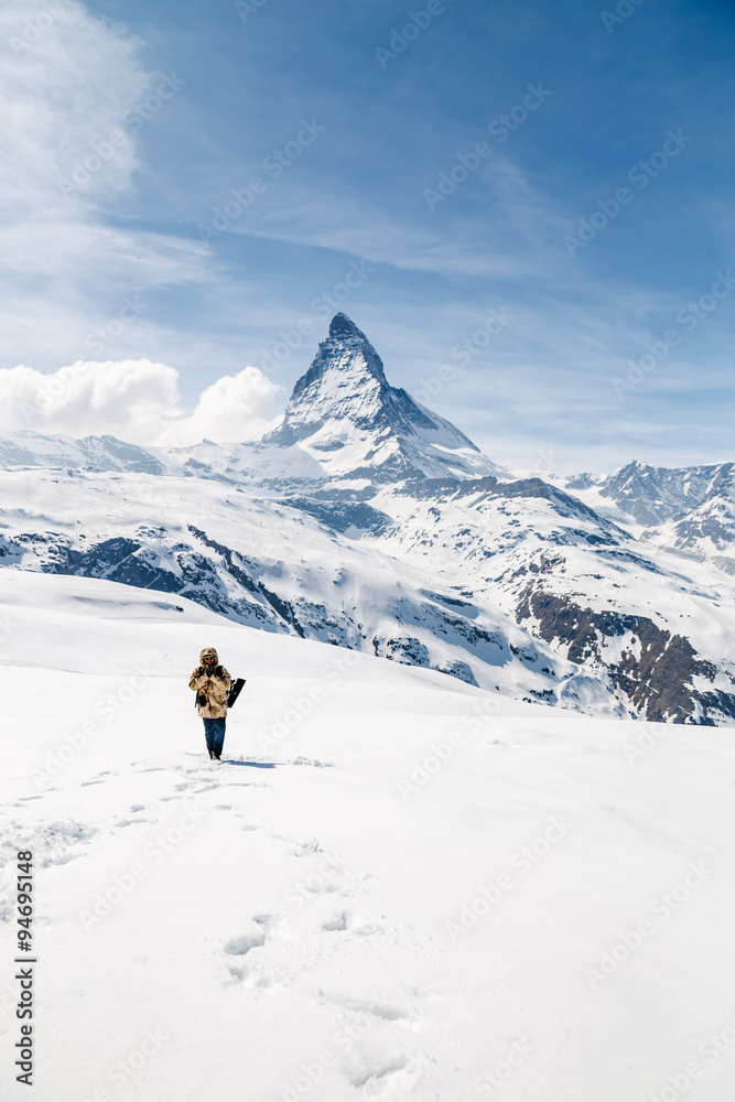 A man pay respect with the background of Matterhorn.
