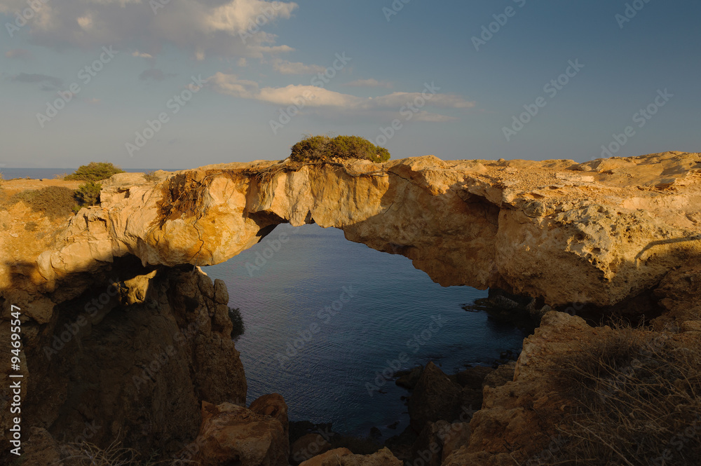 Natural Rock Bridge at Cape Greco near Ayia Napa in the evening light. Cyprus