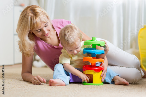 mother and kid playing with...