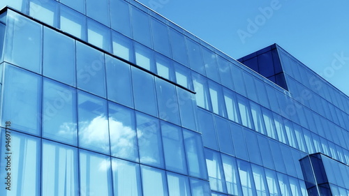 Corporate Blue Building clouds Reflection on window glass
