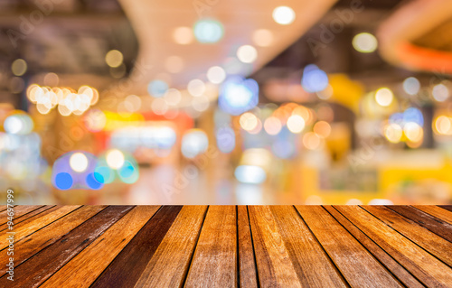 Empty wood table and Coffee shop blur background with bokeh imag