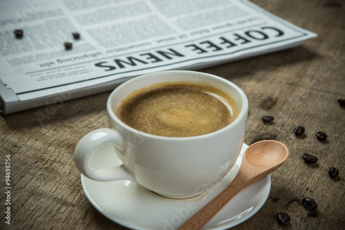 Close up glasses on newspaper and Coffee on the wooden table in