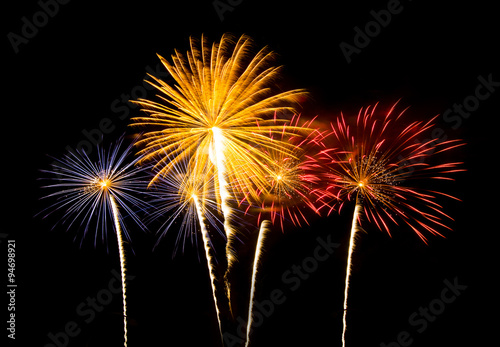 Colorful fireworks of various colors over night sky  - Vibrant c