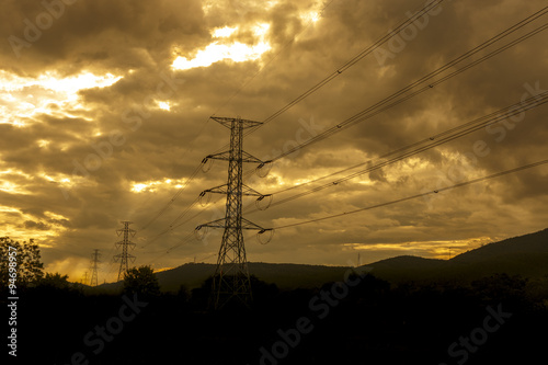 Sun setting behind the silhouette of electricity pylons - Vibran
