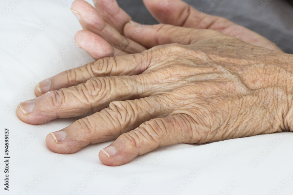 Fototapeta premium Old hands on the bed