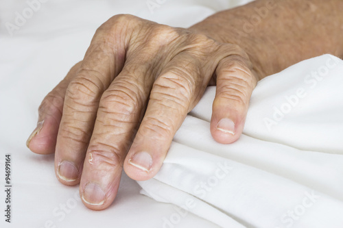 Photos Old hands on the bed