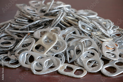 used aluminum can openers on wooden table