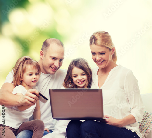 happy family with laptop computer and credit card