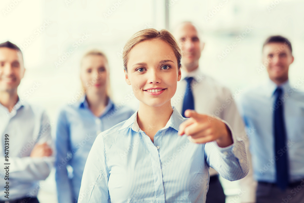 smiling businesswoman pointing finger on you smiling businesswoman pointing finger on you