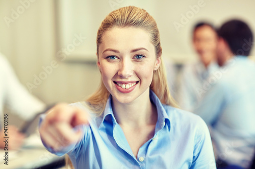 smiling businesswoman pointing finger on you