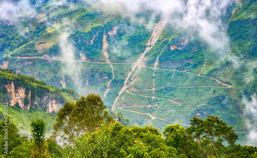 Supply dangerous winding road passes with dirt roads winding halfway up the mountain side without any corridor of protection. This beautiful stretch of road as well as in Ha Giang, Vietnam