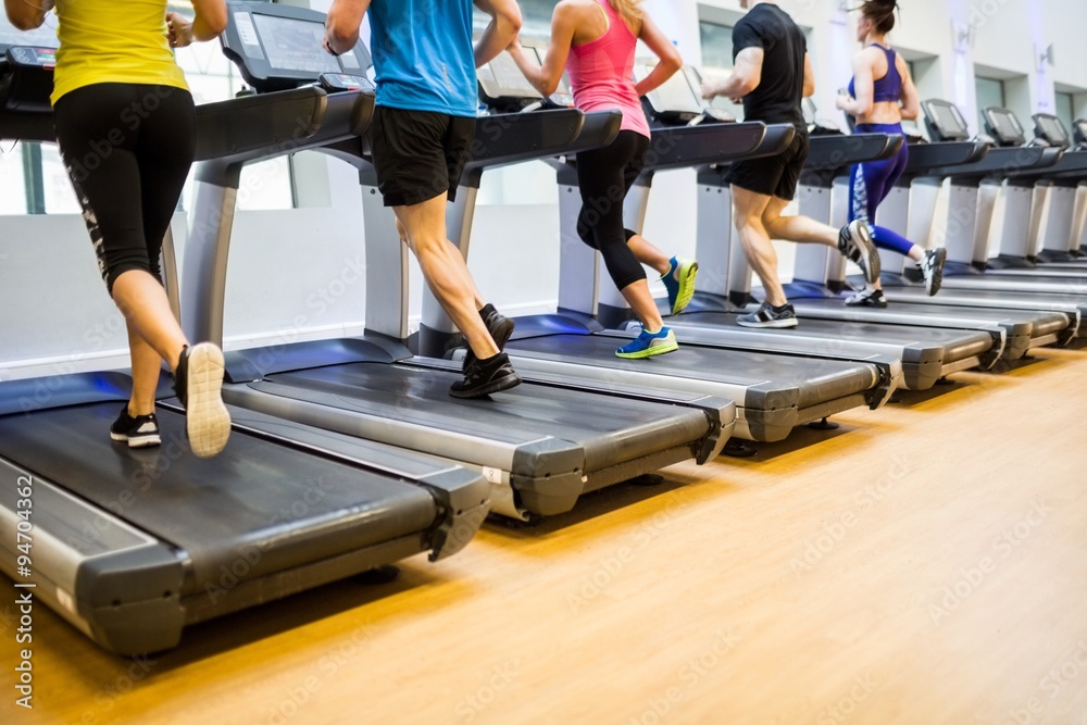 Fototapeta premium Fit people jogging on treadmills