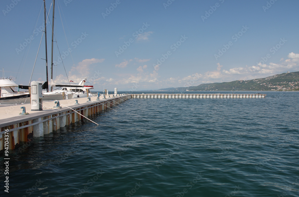 Pier for motor boats and sailboats in harbor in Trieste, Italy