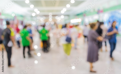 blurred image of people at trade show for background usage .