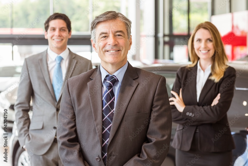Group of smiling business team standing together Group of smiling business team standing together